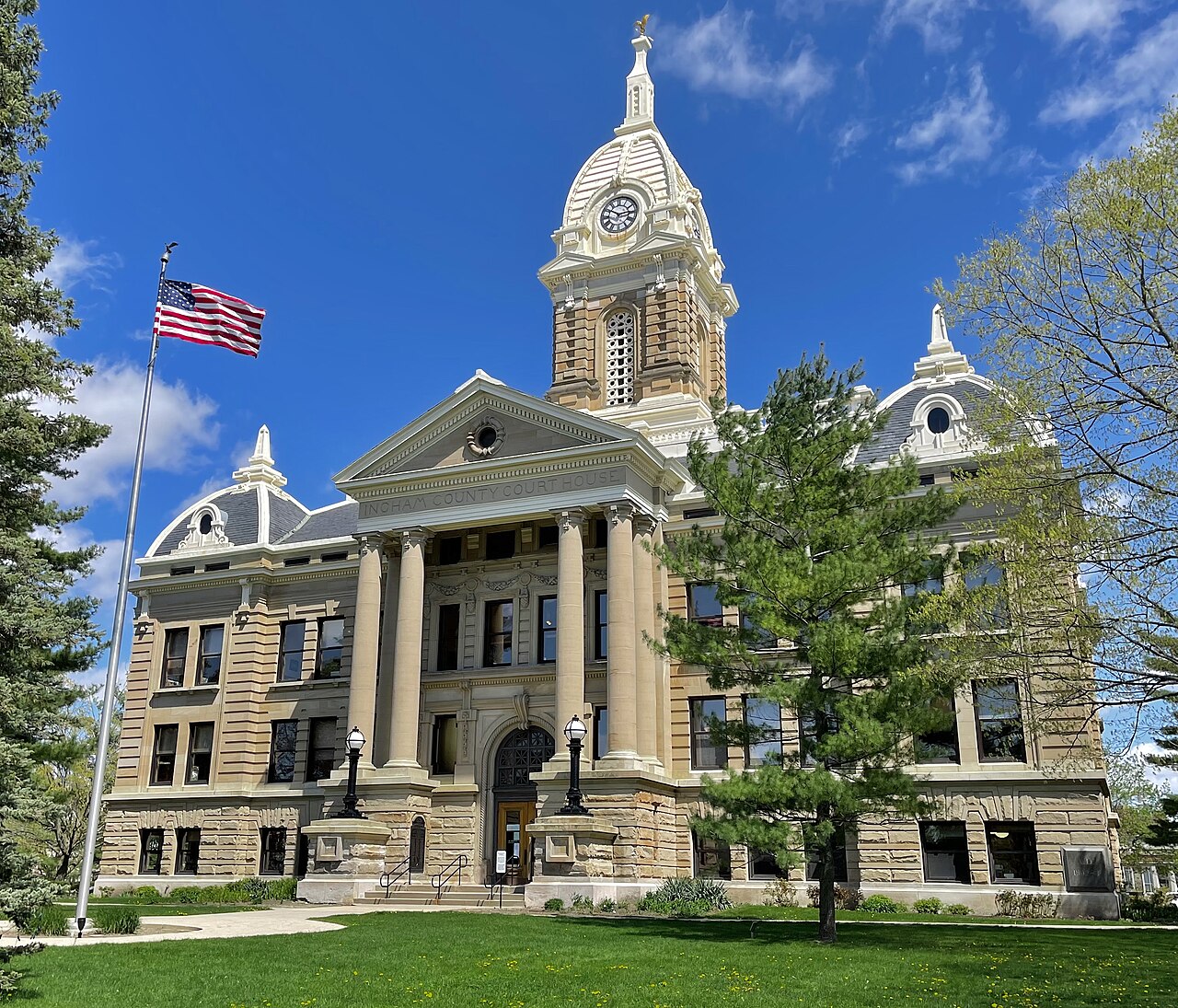 Ingham County Courthouse in Mason with an American flag flying beside it